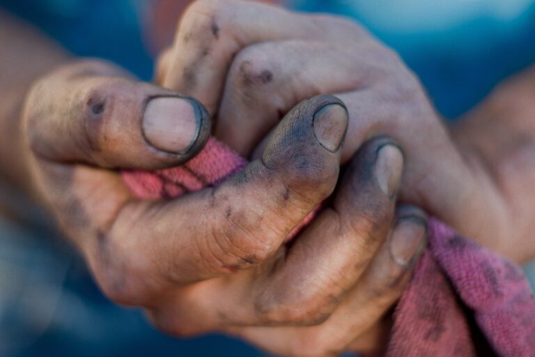 Closeup of a trades man's dirtied, scratched hands after working on a trade or job site